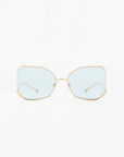 A pair of **Painter** sunglasses by **For Art's Sake®** with geometric octagonal frames and gold-plated stainless steel edges. The ultra-lightweight Nylon lenses are lightly tinted blue, providing 100% UVA & UVB protection. The temples are thin with matching gold-colored tips. The background is a plain white.