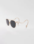For Art's Sake® Birthday Cake-Blue sunglasses feature gold rims, dark lenses, and wavy temples with faux pearl tips, shown against a plain white background.