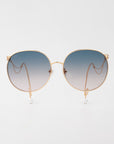 The For Art's Sake® Birthday Cake-Blue sunglasses feature round gold frames, blue gradient lenses, and delicate gold arms finished with faux pearl earring-inspired details, set against a plain white background.