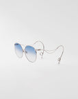 For Art's Sake® Birthday Cake-Blue sunglasses feature thin silver metal frames, blue gradient lenses, and curved temples ending in loops like unique earrings, displayed on a plain white background.