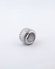 The Woven Ring by For Art's Sake® is a silver, 18kt gold-plated piece featuring a wide band with ribbed texture on its exterior. Displayed against a plain white background, the design boasts vertical grooves encircling the entire circumference.