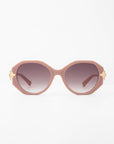 A pair of oversized, rounded sunglasses with light pink, handmade acetate frames and gradient dark lenses. The temples are adorned with gold-plated detailing on each side, adding a touch of elegance to the design. This is the For Art's Sake® Seaside model. The background is plain white.