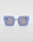 Eos - Blue sunglasses by For Art's Sake® (ONLY 2 LEFT) feature light blue, oversized square frames with dark lenses and bold wide arms, shown against a plain white background.