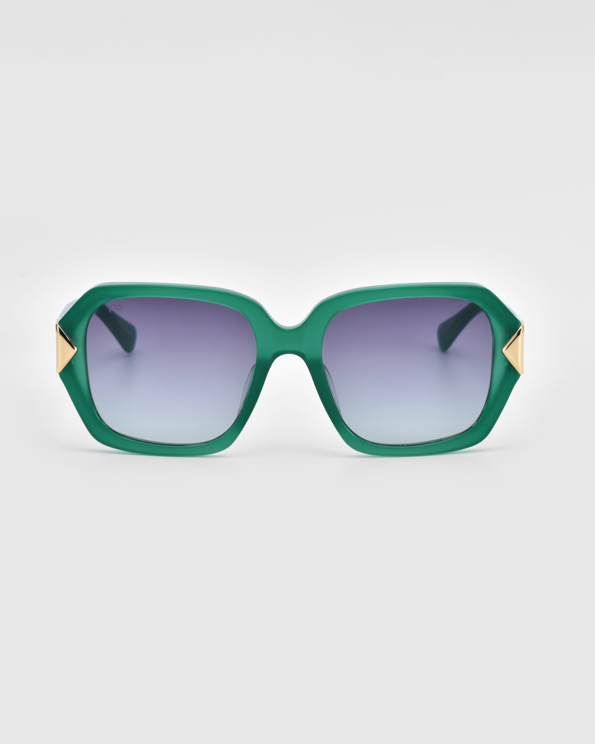 The Frankie sunglasses by For Art's Sake® feature stylish, chunky acetate frames in a green rectangular design with gradient dark lenses. Each temple is adorned with small, gold triangular accents. The background is plain white.