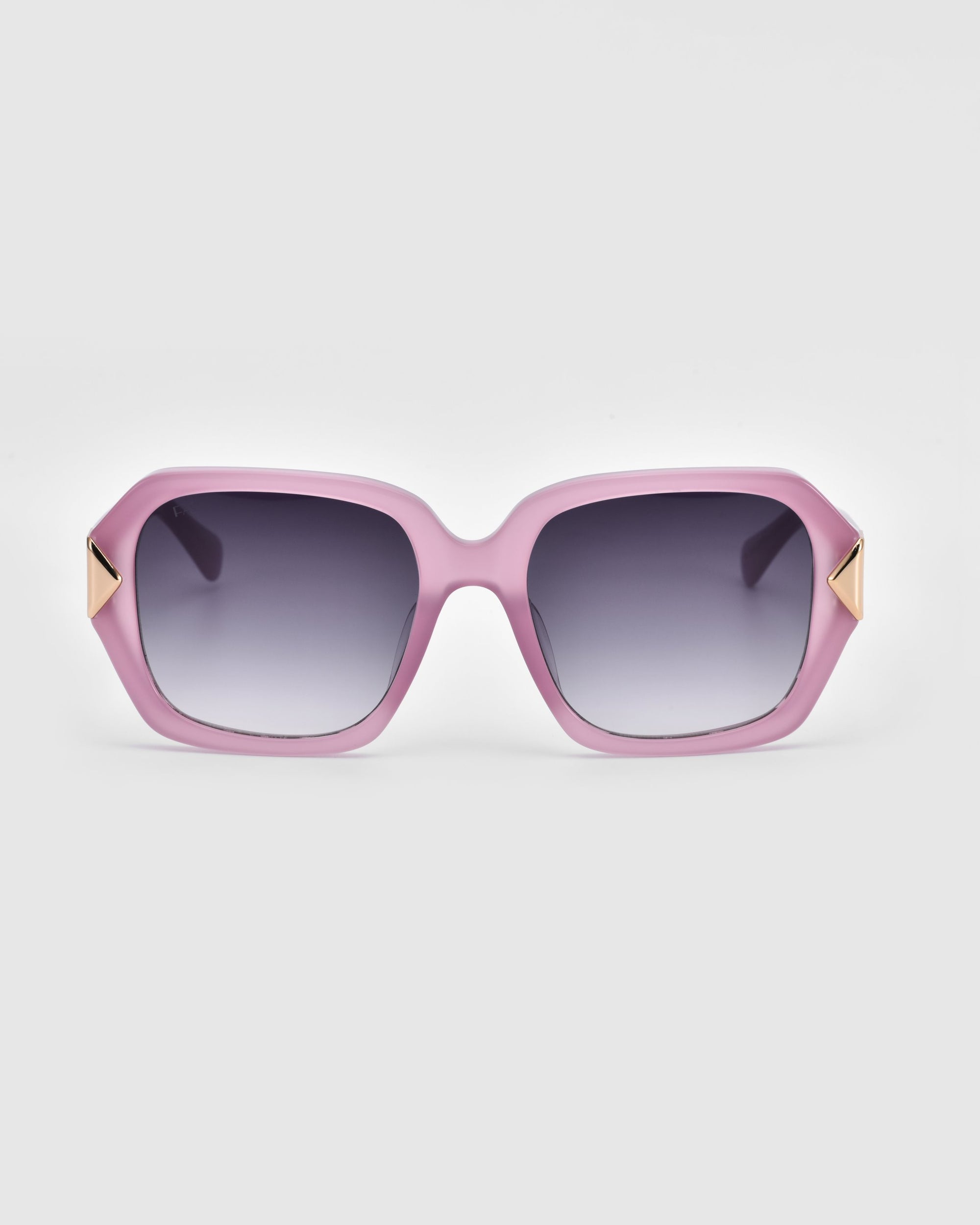 For Art's Sake® Frankie Plum sunglasses feature oversized pink geometric rectangular frames, dark gradient lenses, and gold triangle accents at the corners, shown on a plain light gray background.
