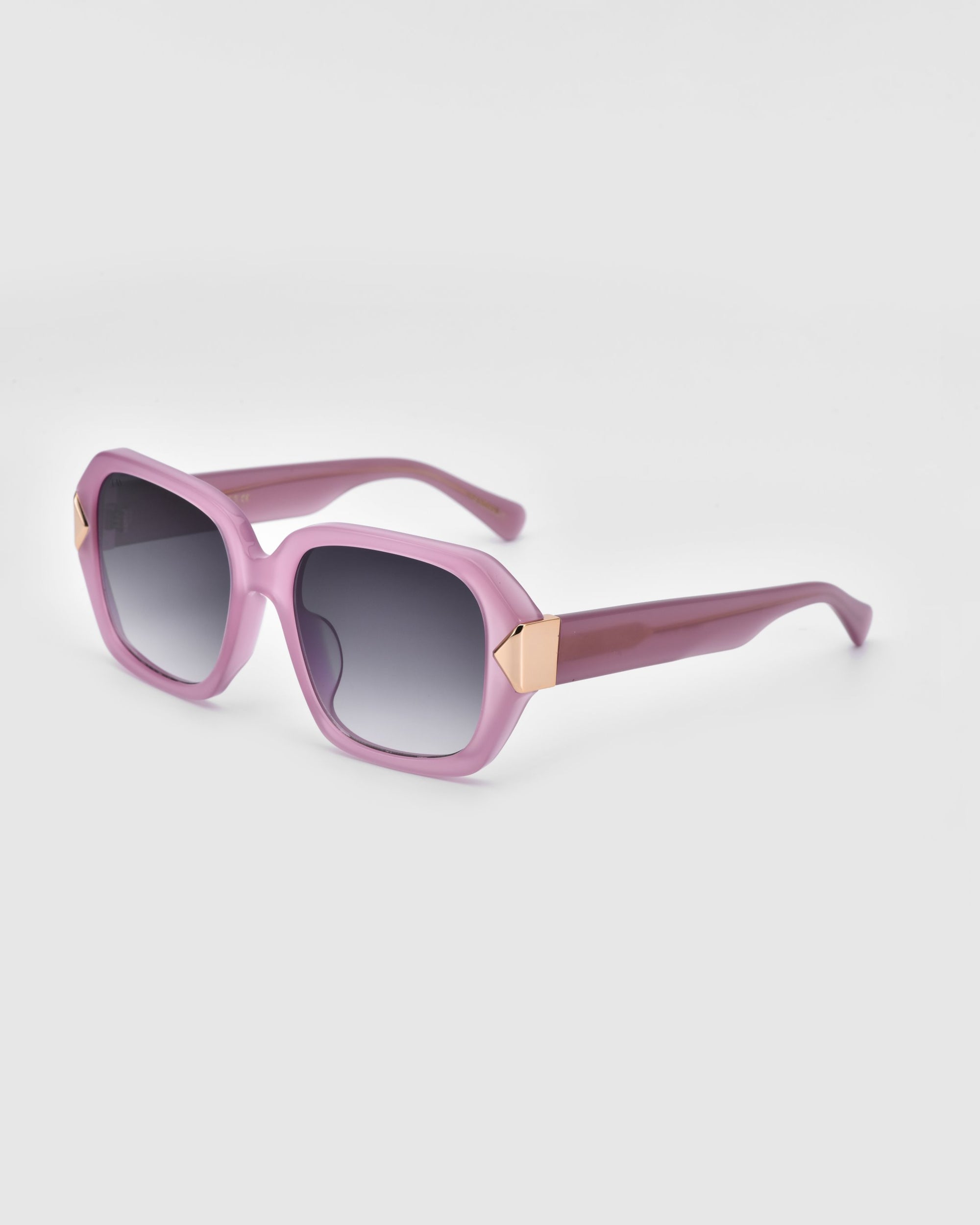 The Frankie Plum sunglasses by For Art's Sake® feature an oversized pink geometric frame, dark gradient lenses, and gold hinge accents, shown against a simple light background.