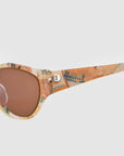 Close-up of For Art's Sake® Vincent Van Gogh limited edition cat-eye sunglasses with a multicolored artistic frame, "Vincent" in blue on the arm, and brown-tinted lenses.