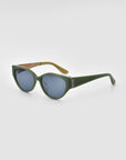 The For Art's Sake® Vincent Van Gogh green oval cat-eye sunglasses feature thick frames and blue-tinted lenses, displayed at an angle on a light gray background—an eye-catching choice for any eyewear collector.