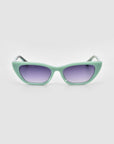 For Art's Sake® Claude Monet: mint green cat-eye sunglasses with purple-tinted lenses, shown on a plain light gray background.
