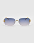 For Art's Sake® Rose Garden sunglasses boast oversized frameless gradient blue lenses, gold-tone temples, and decorative flower accents on the hinges against a plain gray background.