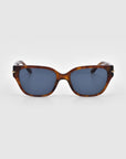 The Rosie sunglasses from For Art's Sake®'s Rose Garden Collection have tortoiseshell cat-eye acetate frames and dark lenses, pictured on a plain, light gray background.