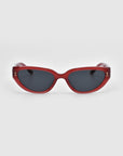 The Lush cat-eye sunglasses by For Art's Sake® feature red frames with dark lenses, crafted from premium materials, and are showcased against a plain white background.