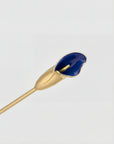 The For Art’s Sake® Calla I features a gold metal stem and glossy deep blue, flower-shaped tip, resembling a hand-painted Calla Lily sculpture displayed on a plain light background.