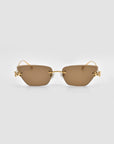 Florist sunglasses by For Art's Sake® feature brown rectangular frameless lenses with gold temples and small sculpted accents on the outer edges, displayed against a plain light gray background.