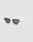 Florist sunglasses by For Art's Sake® feature dark square lenses, thin gold arms, and sculpted floral accents at the corners, displayed on a light gray background.