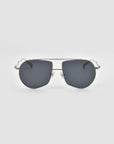 The For Art’s Sake® Lines sunglasses feature an oversized aviator shape, sculpted temples, dark lenses, and a thin silver metal frame, displayed against a plain light gray background.