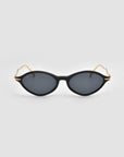 For Art's Sake® Totto black cat-eye sunglasses with dark lenses and gold sculpted acetate and metal temples, shown on a plain light gray background.