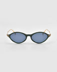 A pair of For Art's Sake® Totto sunglasses with dark green acetate and metal cat-eye frames, blue-tinted lenses, and slim gold sculpted temples are displayed against a plain light gray background.