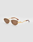 For Art's Sake® Abstraction II sunglasses feature statement frames, gold accents, brown-tinted lenses, and brown tips on the arms, shown against a plain light gray background.