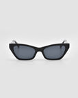 The For Art's Sake® Mesa II sunglasses are black luxury cat-eye frames with dark tinted lenses, crafted from premium acetate, displayed against a plain light gray background.