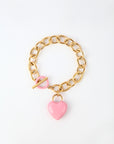 The Kiss Bracelet by For Art's Sake® is crafted with 18k gold, featuring a toggle clasp and an enamel-covered heart charm. The chain boasts large oval links, while the glossy pink heart charm adds a touch of color to the elegant design. Displayed against a plain white background, this piece exudes sophistication.