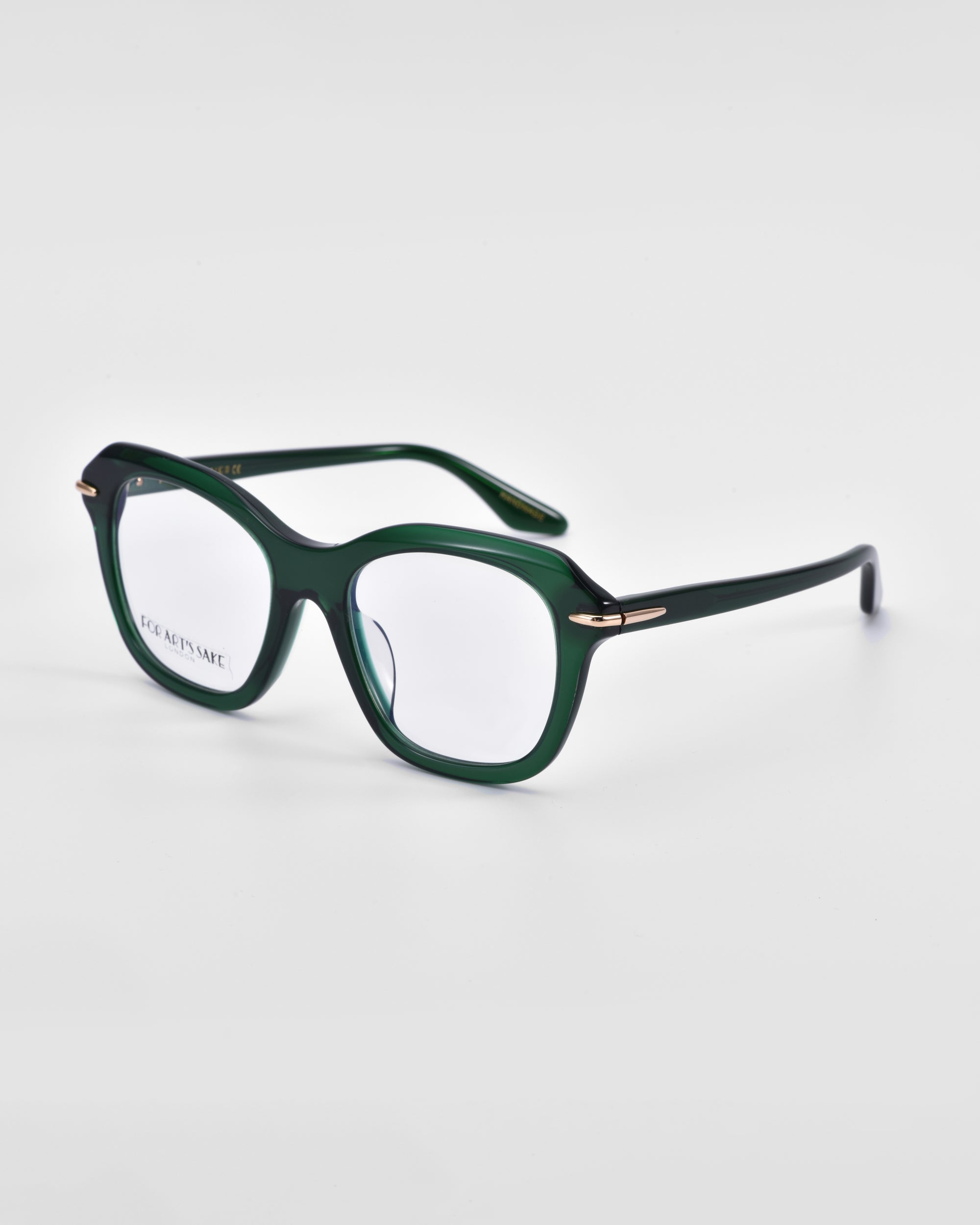 A pair of stylish green rectangular eyeglasses with a glossy finish, featuring 18-karat gold plating near the hinges. The For Art's Sake® Helene frames are sturdy with a slight curve in the arms, while the clear lenses rest on a plain white background.