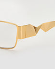 Close-up of For Art's Sake® Origami eyeglasses, featuring geometric gold accents and pleated temples, set against a white background—highlighting their sculptural, origami-inspired design.