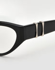 Close-up of the temple of Halo(X) black eyeglasses by For Art's Sake®, showing a sculptural acetate frame and two silver metallic accents on the arm, set against a white background.