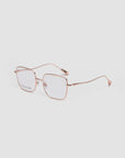 Garden by For Art's Sake® features modern squared metal glasses with thin rose gold frames and clear rectangular lenses, shown on a light gray background—lightweight and comfortable for everyday style.