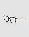 For Art's Sake® Claudia eyeglasses featuring thick black square frames and gold sculpted temples, shown on a plain light background.