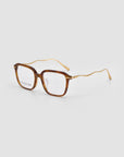 For Art's Sake® Claudia eyeglasses feature brown square acetate frames and distinct wavy gold metal temples, artfully blending acetate and metal, shown on a light gray background.