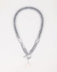 A silver chain necklace with a chunky flat-curb interwoven design. It features a toggle clasp and a single dangling freshwater pearl charm, creating a blend of elegance and modern style. The Girlfriend Necklace by For Art's Sake® is displayed on a plain, light background.