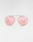 For Art's Sake® Yoyo - ARC sunglasses feature a gold-framed aviator style with pink-tinted lenses and luxurious 18-karat gold plating, set against a plain white background.