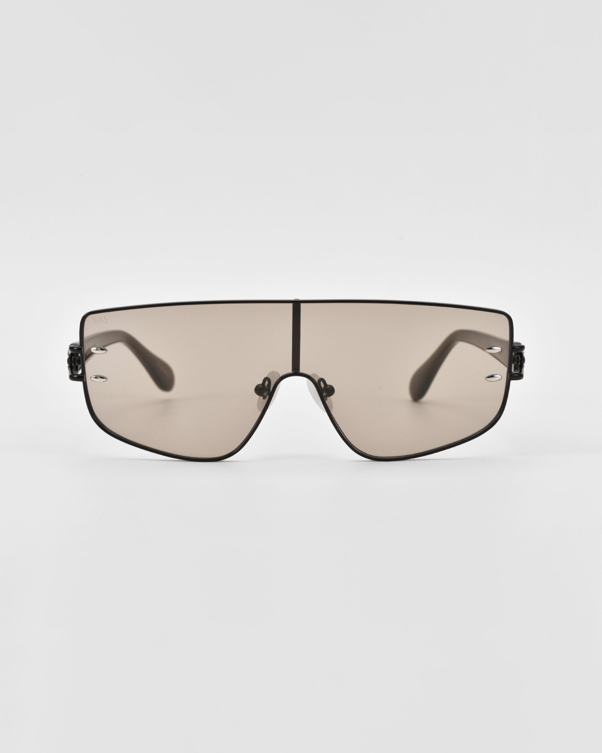 A pair of sleek, futuristic For Art's Sake® Flare sunglasses with a single continuous lens across the front, framed by thin, black metal. This luxury eyewear boasts a minimalist design with no visible hinges or branding, featuring a slightly curved shape and dark-tinted lenses.