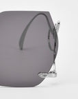 Close-up of For Art's Sake® "Cry Me a River" sunglasses, featuring bold, large dark square lenses and silver metal frames. Only part of these limited edition statement shades is shown against a white background.