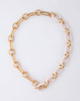 The Bexley Necklace by For Art's Sake® showcases chunky resin links with alternating large gold and ivory ovals, finished in radiant 18-karat gold plating and secured with a toggle clasp, shown on a plain white background.