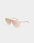The Alien sunglasses by For Art's Sake® feature an oversized, avant-garde rose gold frame with pink gradient lenses, a single brow bar, pink-tipped arms, UV protection, and are presented on a plain white background.