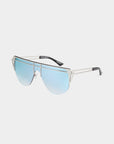 The Alien eyewear by For Art's Sake® is a pair of avant-garde, aviator-style sunglasses featuring silver metal frames and gradient blue lenses. This stylish, handcrafted product showcases a double bridge, minimalist temples with black ends, and offers UV protection against harmful rays. The background is white.