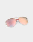 Introducing the Dark Eyes sunglasses by For Art's Sake® — a pair of aviator-style shades featuring sleek, gold-colored stainless steel frames and reflective, gradient nylon lenses. The lenses transition beautifully from pink at the top to a soft blue at the bottom while providing 100% UV protection. Presented against a simple, light background, these sunglasses are both stylish and functional.