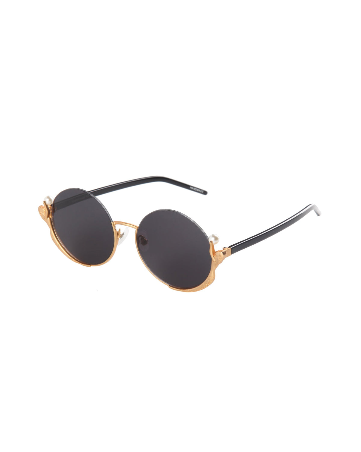 The Ariel sunglasses by For Art's Sake® feature round dark lenses, gold metal frames, and sleek black arms, shown on a white background.