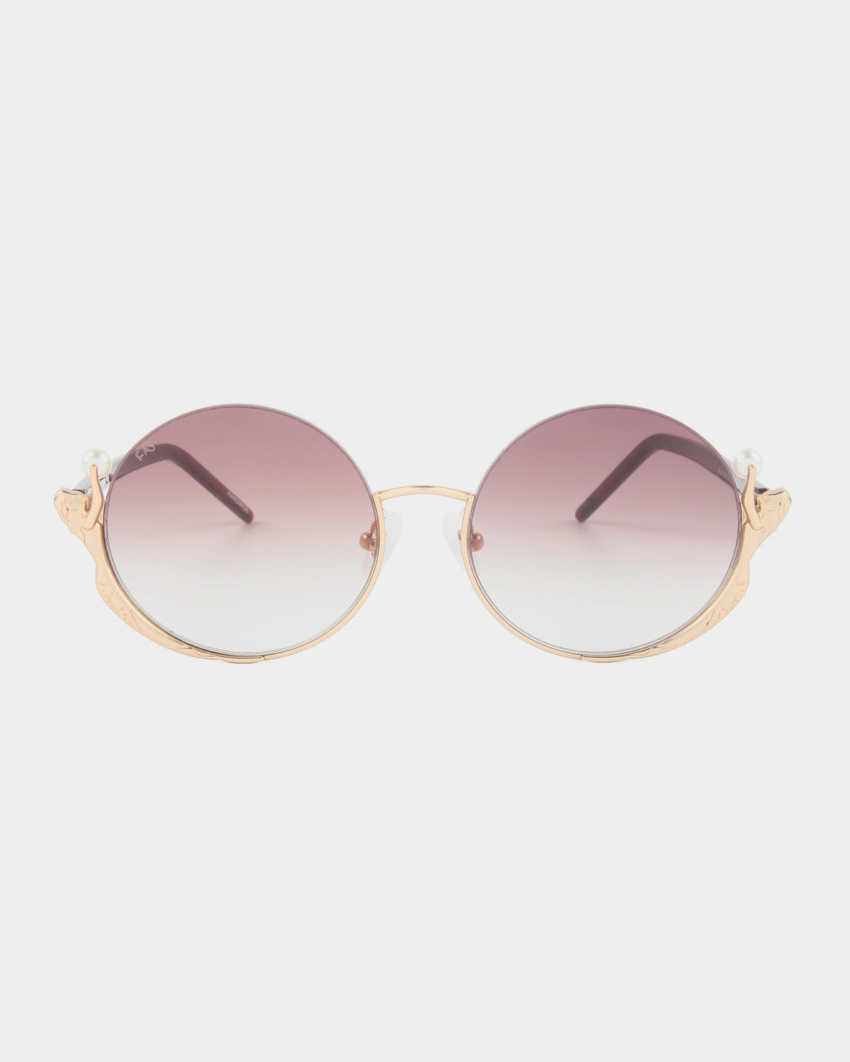The Ariel sunglasses by For Art's Sake® feature round gold frames, gradient pink lenses, and pearl-accented temples—making them a standout accessory, shown on a white background.