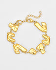 The Forms Bracelet by For Art’s Sake® features irregular abstract gold links joined by small rings, adjustable chain, and lobster clasp, displayed on a plain light background.