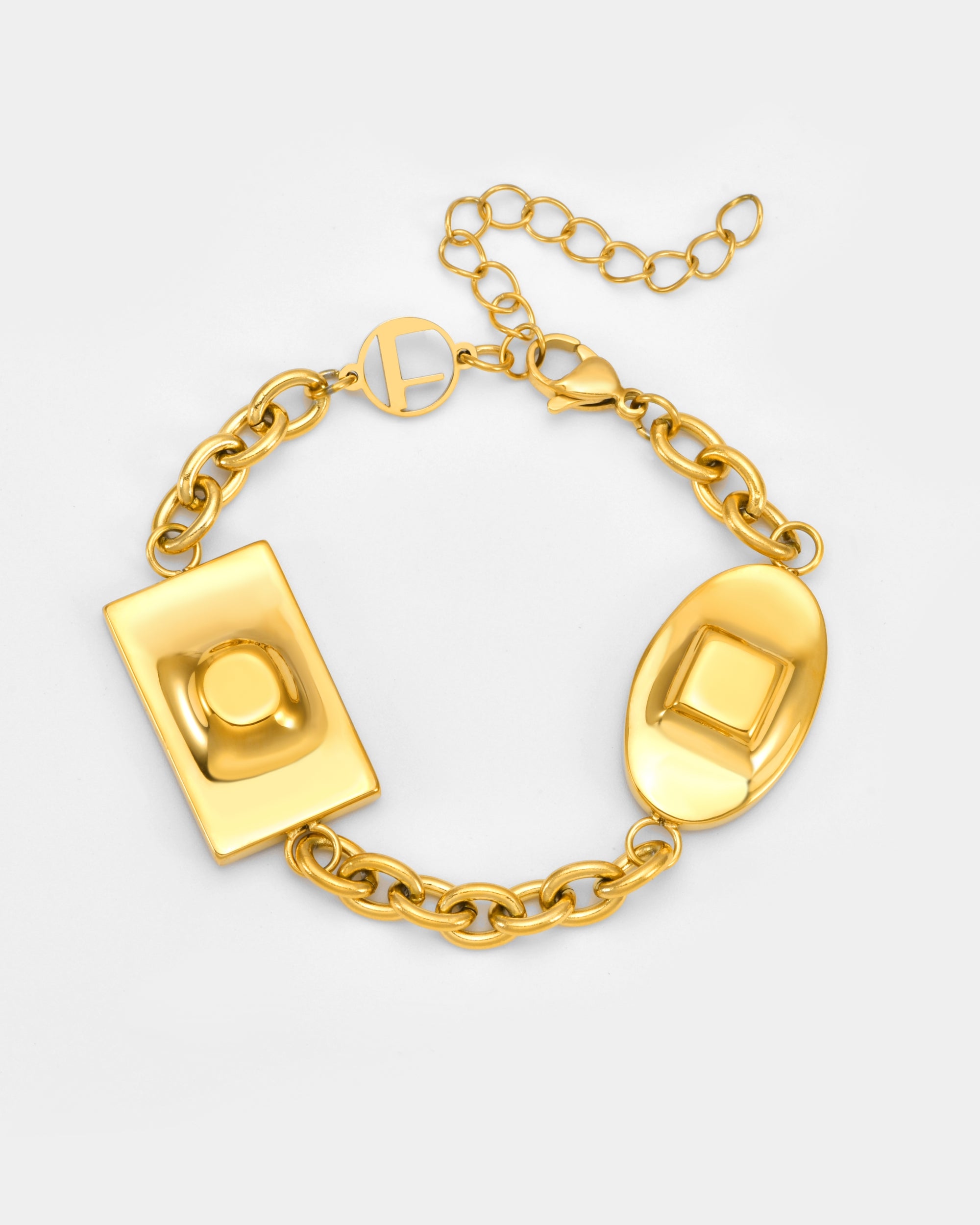 The Geometry Bracelet by For Art's Sake® is a gold chain with rectangular and oval raised-design charms, plus an adjustable clasp with a round charm, shown against a plain white background.