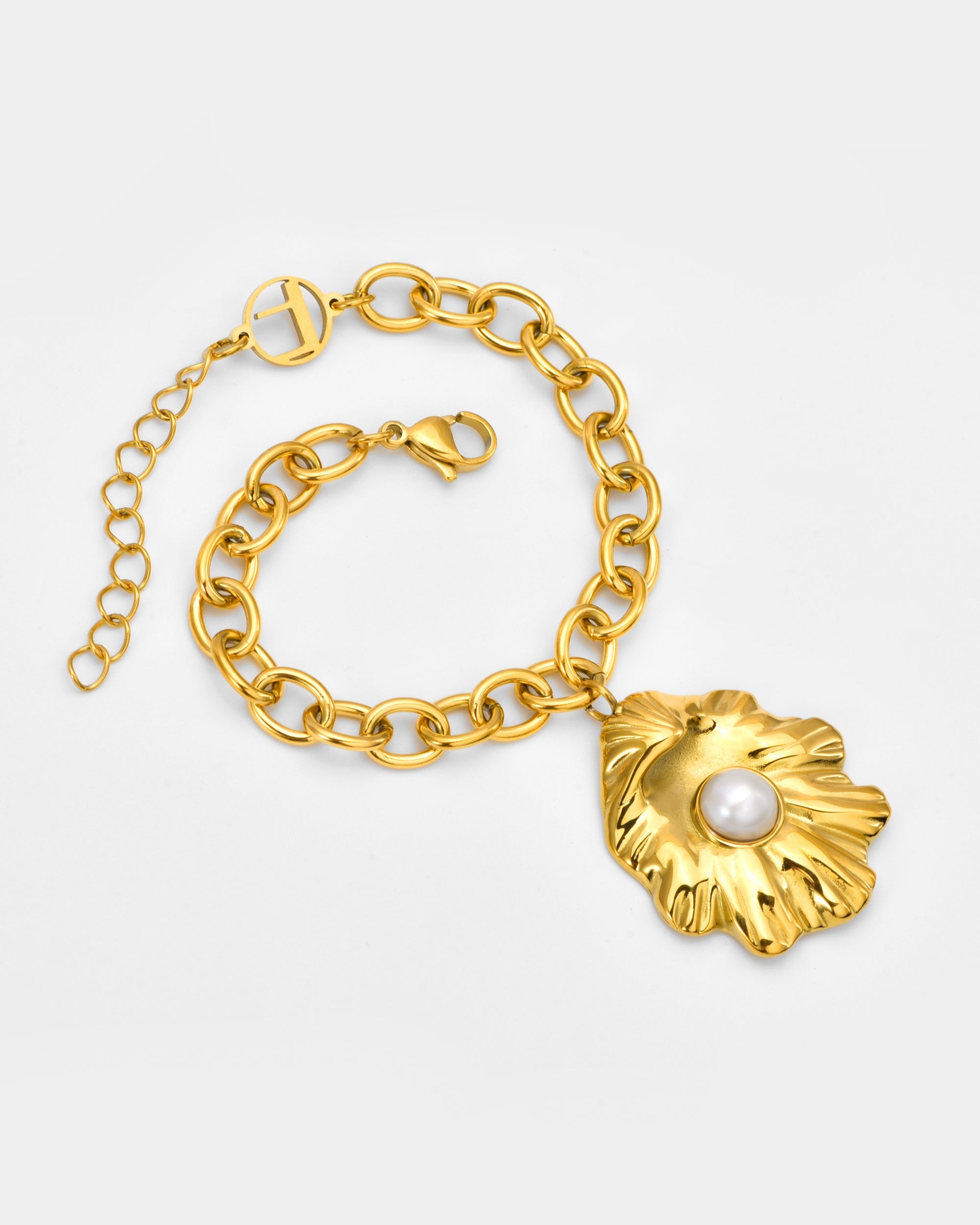 For Art's Sake® The Shell Pendant Bracelet features a gold chain with a large, textured leaf-shaped pendant centered by a white pearl. An adjustable extender and lobster clasp offer a custom fit, displayed on a plain light background.