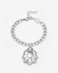 The Shell Pendant Bracelet by For Art's Sake® features a silver seashell-shaped charm with a freshwater pearl at its center, presented on a white background—an elegant touch of coastal jewellery.
