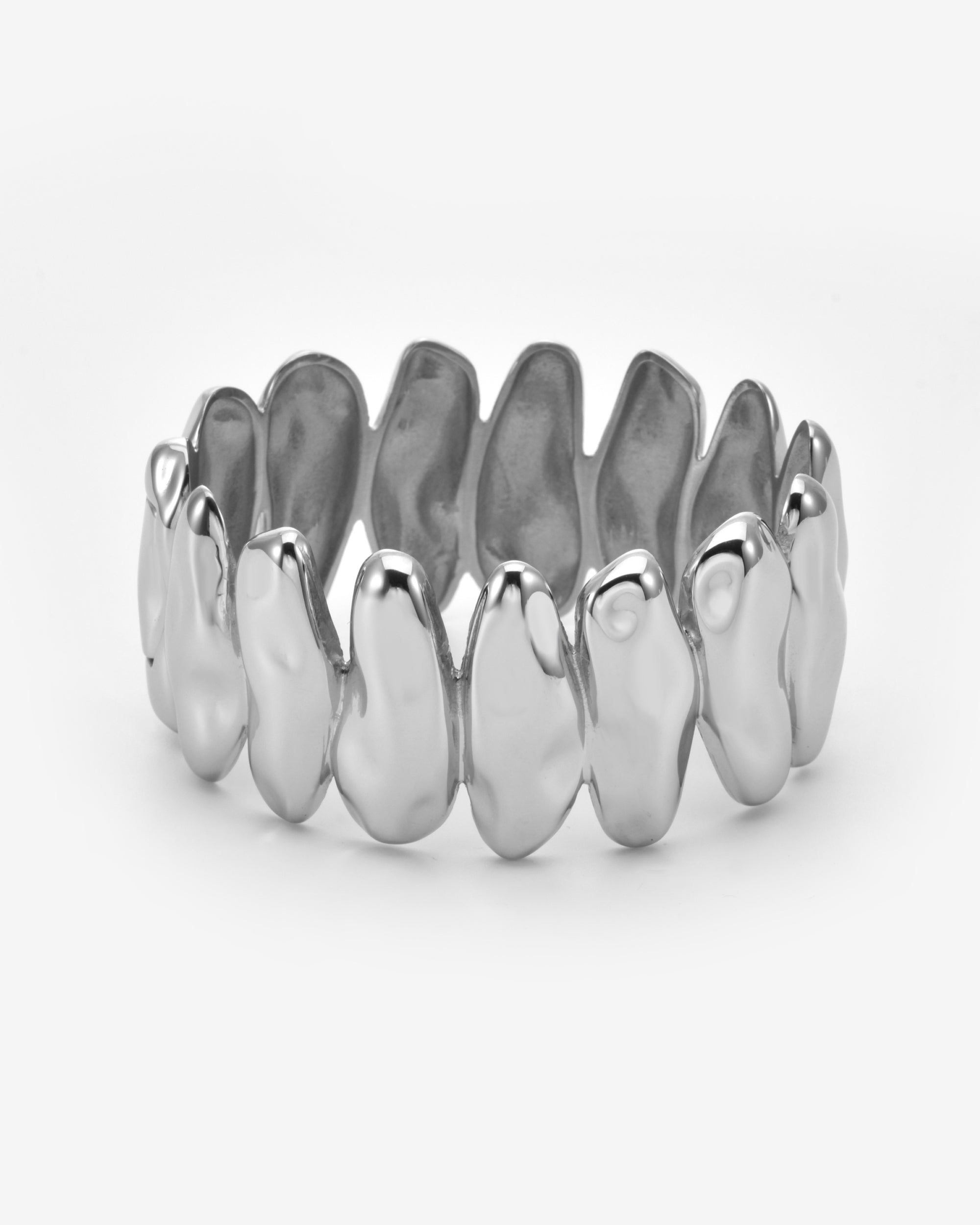 The Forms Bangle by For Art's Sake® is a silver organic metal ring with an irregular design and smooth, rounded shapes linked in a continuous band, displayed on a plain white background.