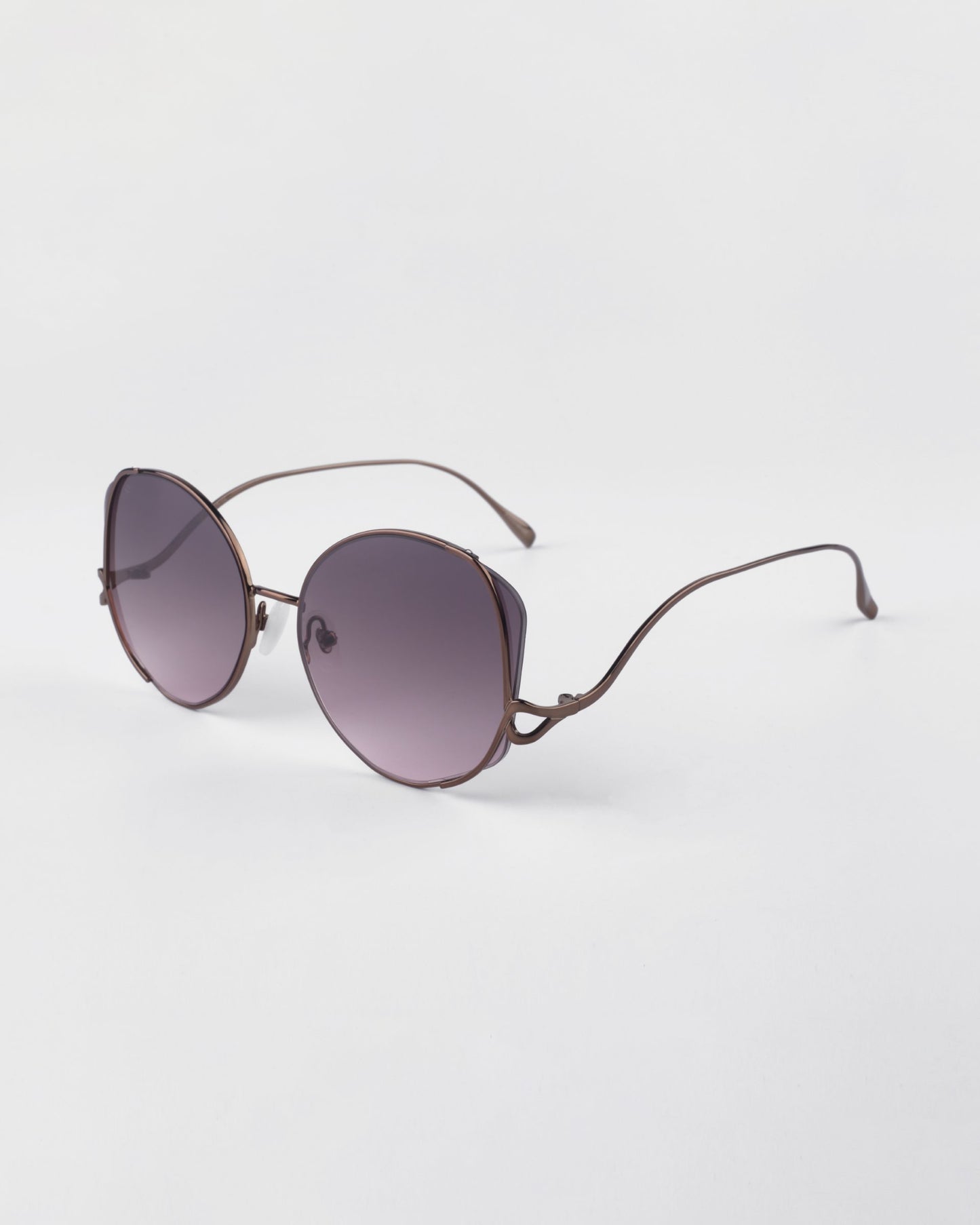 For Art's Sake Canvas sunglasses in Rose. Side view of glasses showing the rose gold metal frames and round shape. 
