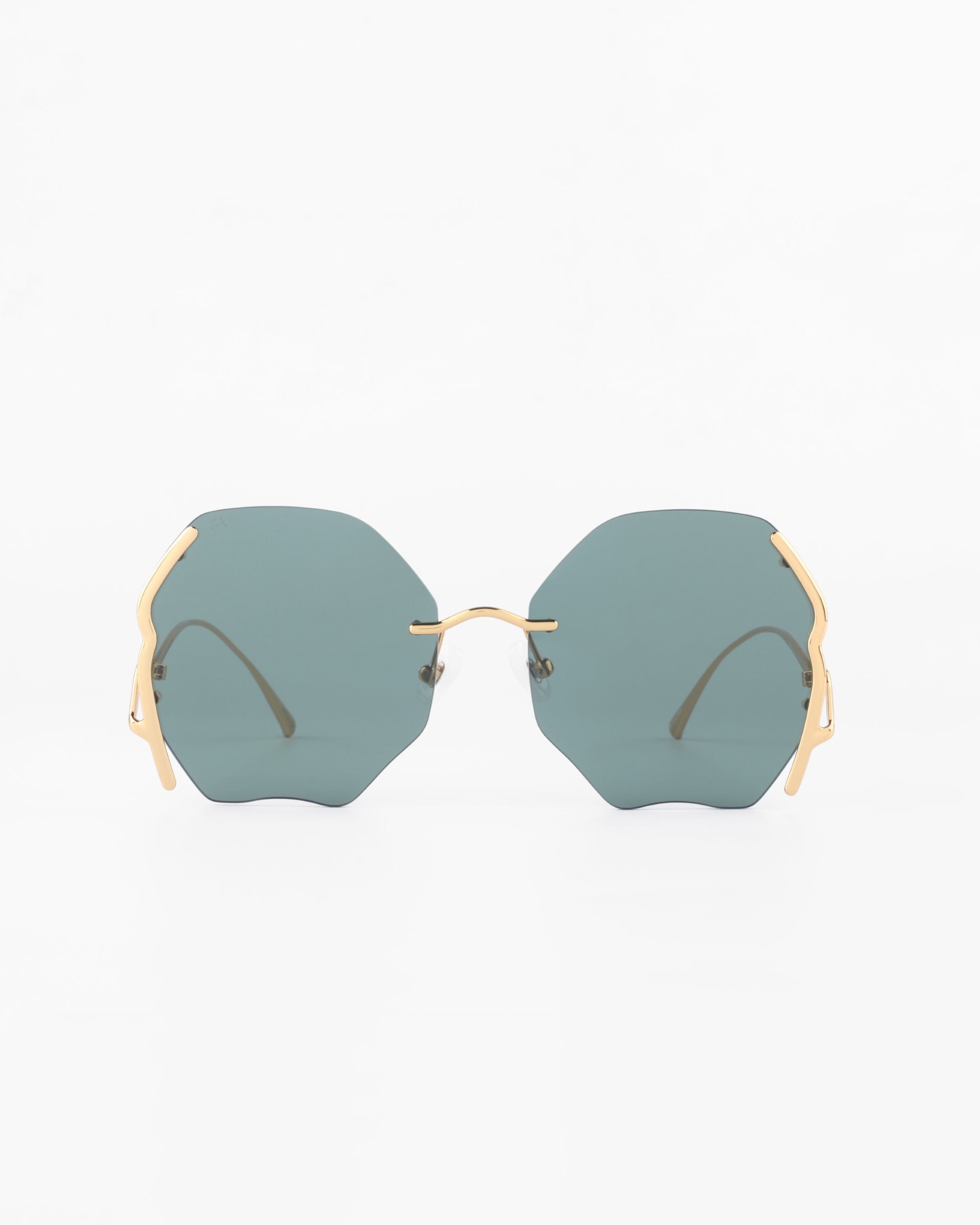 A pair of stylish Century sunglasses from For Art's Sake® with gold-plated stainless steel arms and hinges. The large, dark lenses are uniquely angled, offering a modern and trendy appearance. Boasting 100% UVA & UVB protection, they stand out against the plain white background as the focal point of the image.
