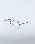 For Art's Sake® Cleo: Black round metal eyeglasses with clear nose pads and transparent temple tips on a light gray background. Final sale—no returns or reselling allowed.
