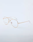 The Cleo eyeglasses by For Art's Sake® feature stylish gold rims and clear lenses, shown on a plain white background. Final sale only.